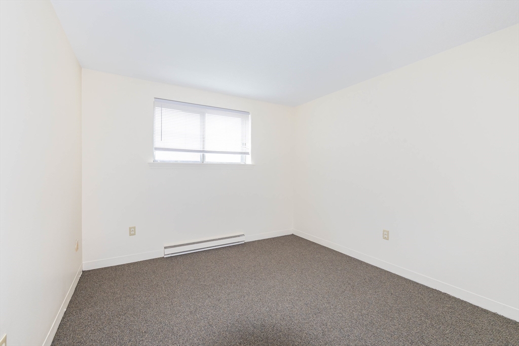 71 Nicholas Road, Unit H Framingham, MA 01701 - Photo 17 of 29 an empty room with a window