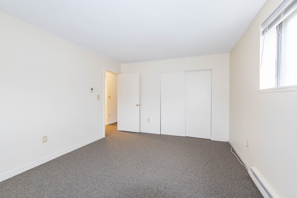 71 Nicholas Road, Unit H Framingham, MA 01701 - Photo 19 of 29 an empty room with windows