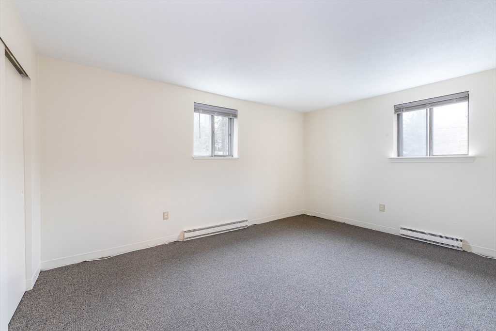 71 Nicholas Road, Unit H Framingham, MA 01701 - Photo 20 of 29 an empty room with a window