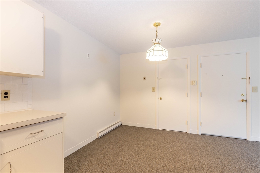 71 Nicholas Road, Unit H Framingham, MA 01701 - Photo 2 of 29 an empty room with windows