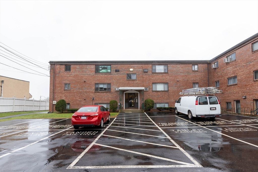 71 Nicholas Road, Unit H Framingham, MA 01701 - Photo 26 of 29 a couple of cars parked in front of a house