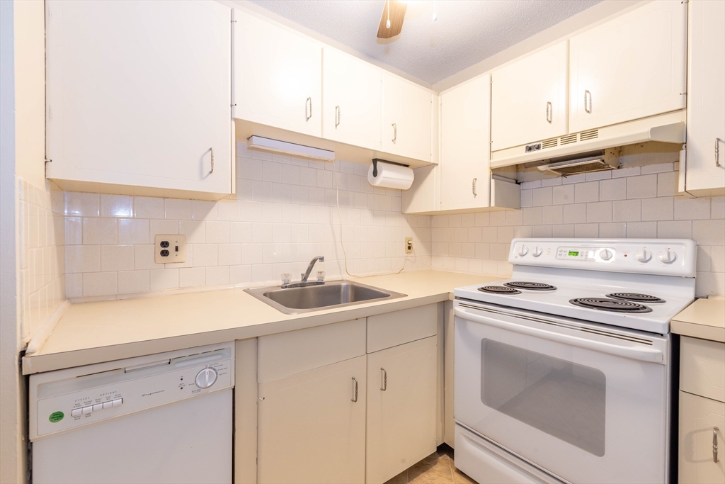 71 Nicholas Road, Unit H Framingham, MA 01701 - Photo 3 of 29 a kitchen with cabinets appliances a sink and a counter top