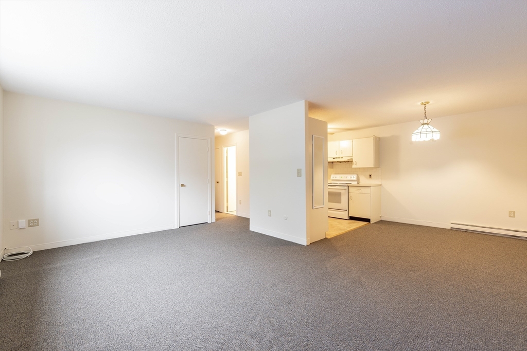 71 Nicholas Road, Unit H Framingham, MA 01701 - Photo 9 of 29 an empty room with a empty space and windows