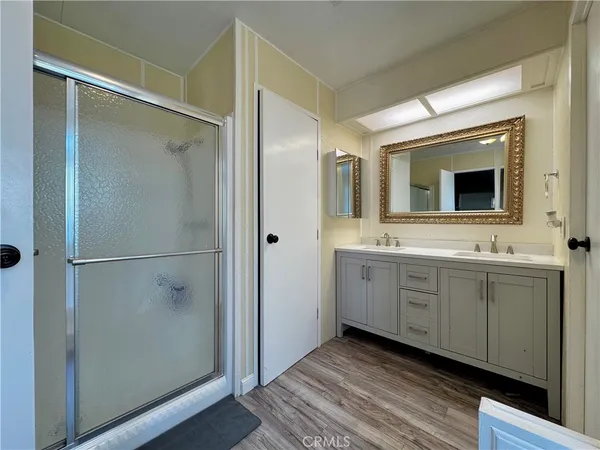 a bathroom with a double vanity sink mirror and toilet