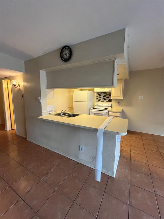 4460 Chaha Road, Unit 205 Garland, TX 75043 - Photo 10 of 27 a kitchen with a sink cabinets and window