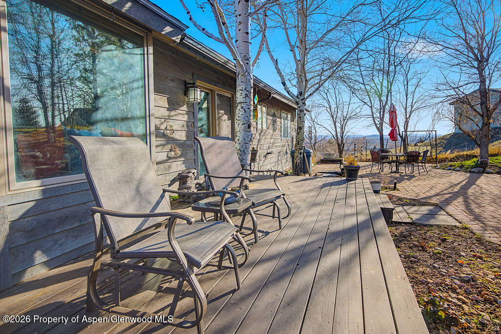 1040 Bryan Way Craig, CO 81625 - Photo 32 of 54 a view of a patio with table and chairs with wooden floor and fence