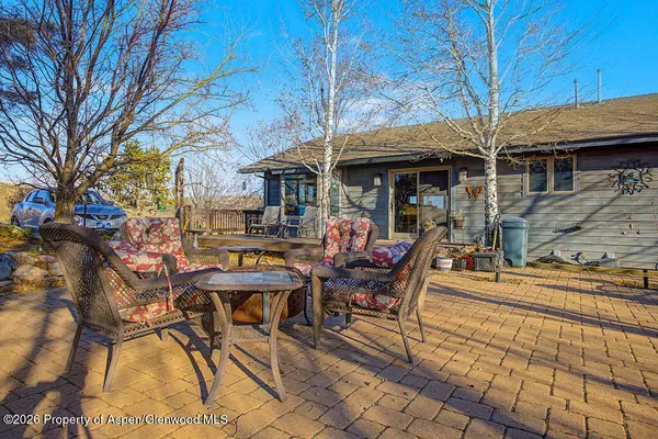 a view of a chairs and table in the patio