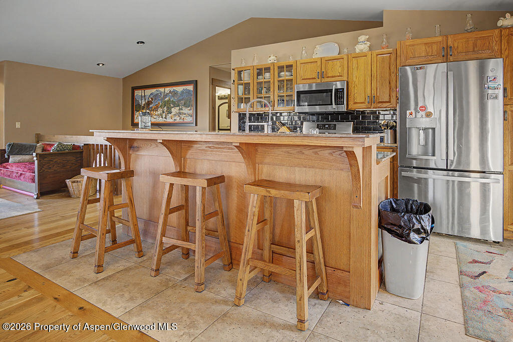1040 Bryan Way Craig, CO 81625 - Photo 8 of 54 a kitchen with stainless steel appliances kitchen island granite countertop a refrigerator and microwave