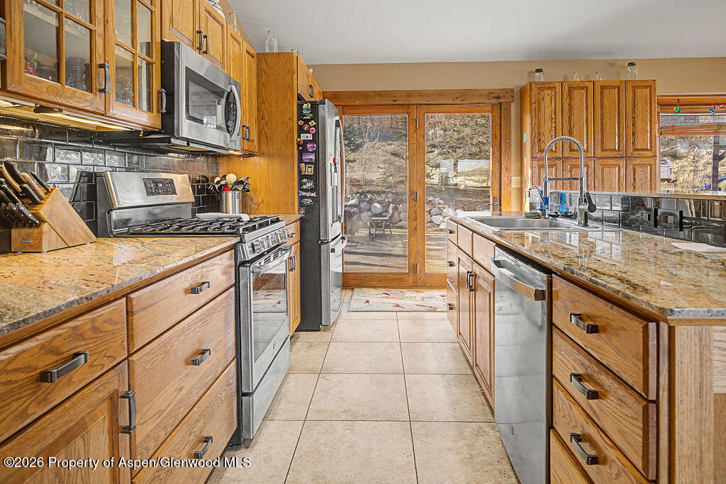 1040 Bryan Way Craig, CO 81625 - Photo 10 of 54 a kitchen with stainless steel appliances granite countertop a stove and a sink