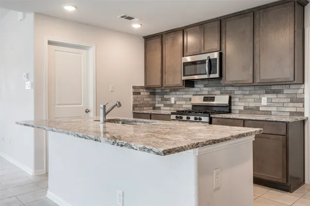 an empty room with fan and windows