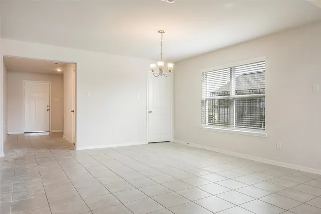 a view of a kitchen with a sink and a refrigerator in it