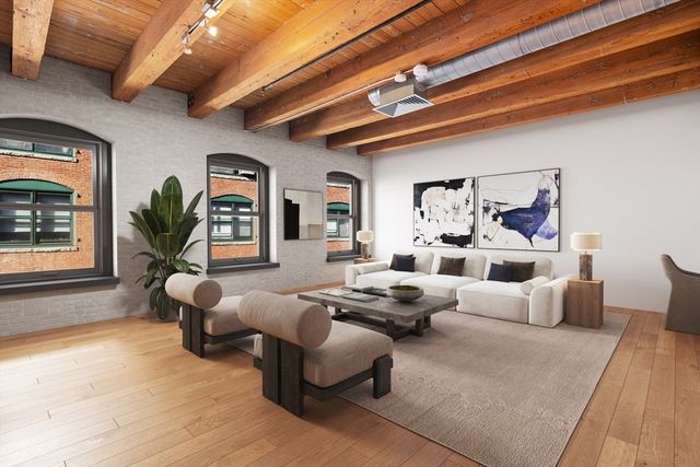 a living room with furniture or couch and a potted plant