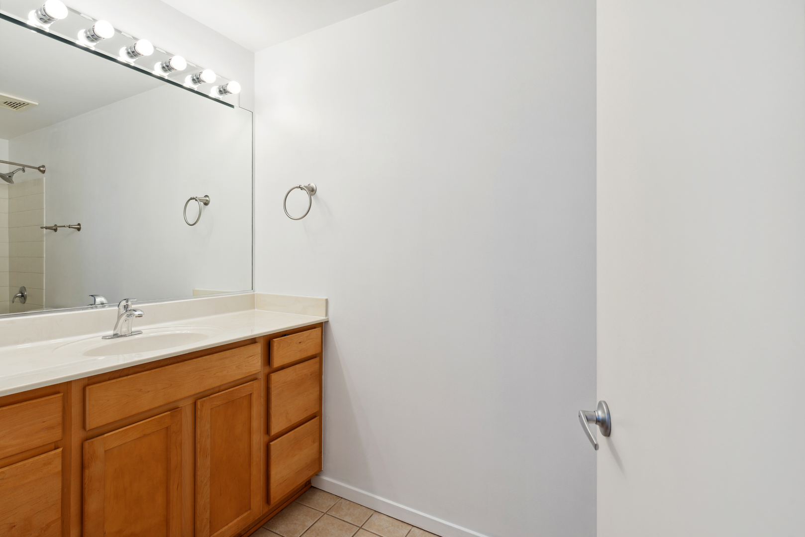 933 West Van Buren Street, Unit 824 Chicago, IL 60607 - Photo 10 of 18 a bathroom with a sink mirror and vanity