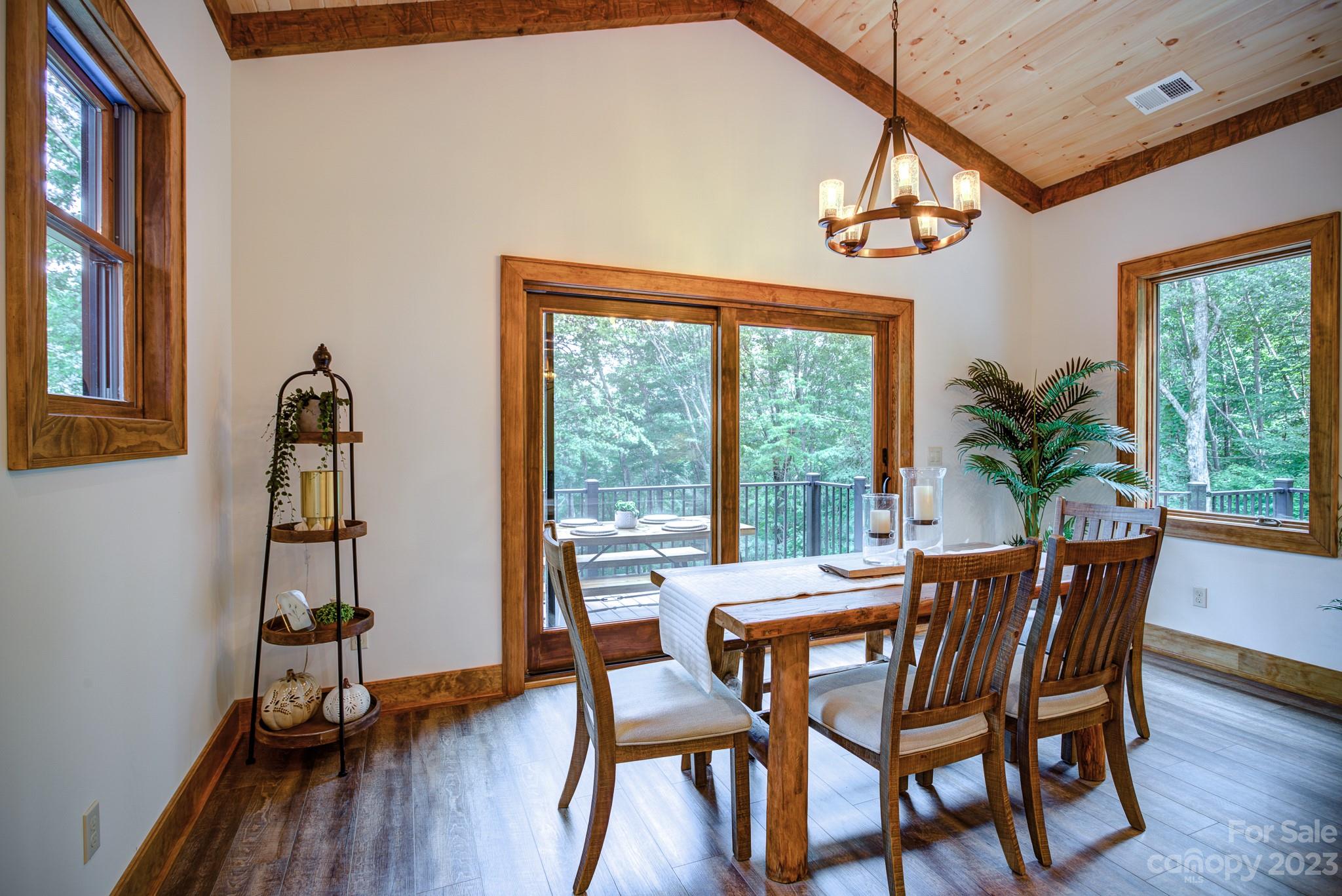 53 Laurel Ridge Lane, Unit 26 Banner Elk, NC 28604 - Photo 13 of 41 a view of a dining room with furniture window and wooden floor