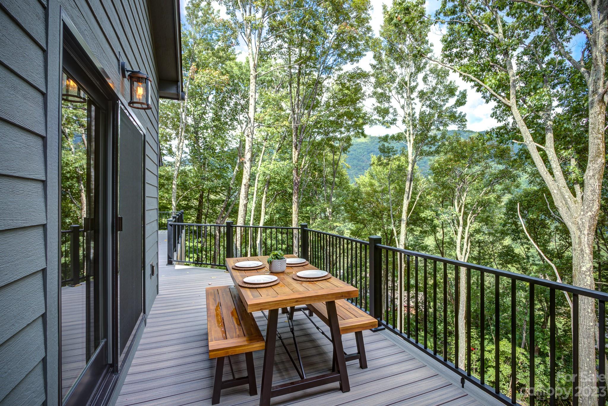 53 Laurel Ridge Lane, Unit 26 Banner Elk, NC 28604 - Photo 14 of 41 a balcony with wooden floor table and chairs