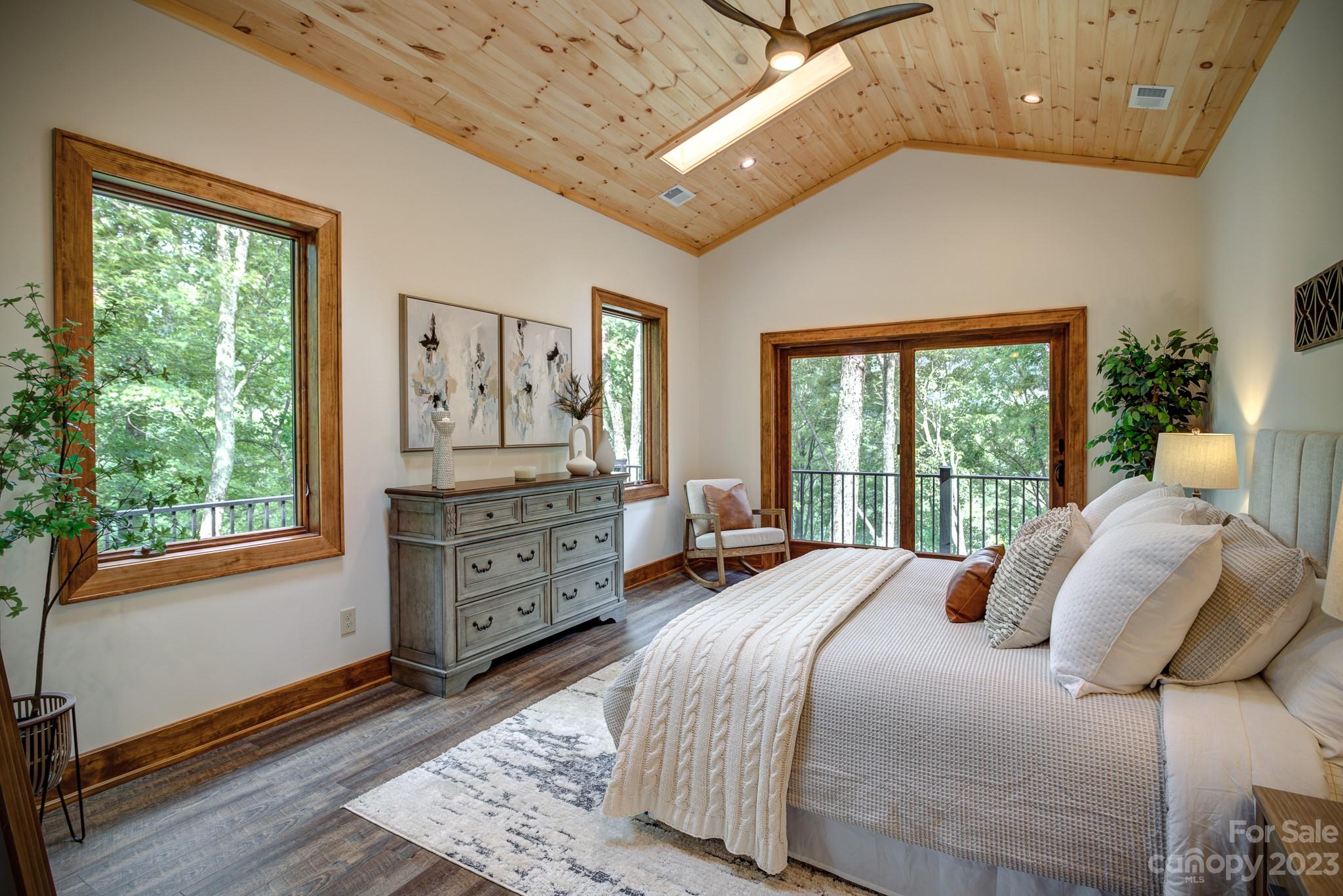53 Laurel Ridge Lane, Unit 26 Banner Elk, NC 28604 - Photo 20 of 41 a bedroom with a bed and wooden floor