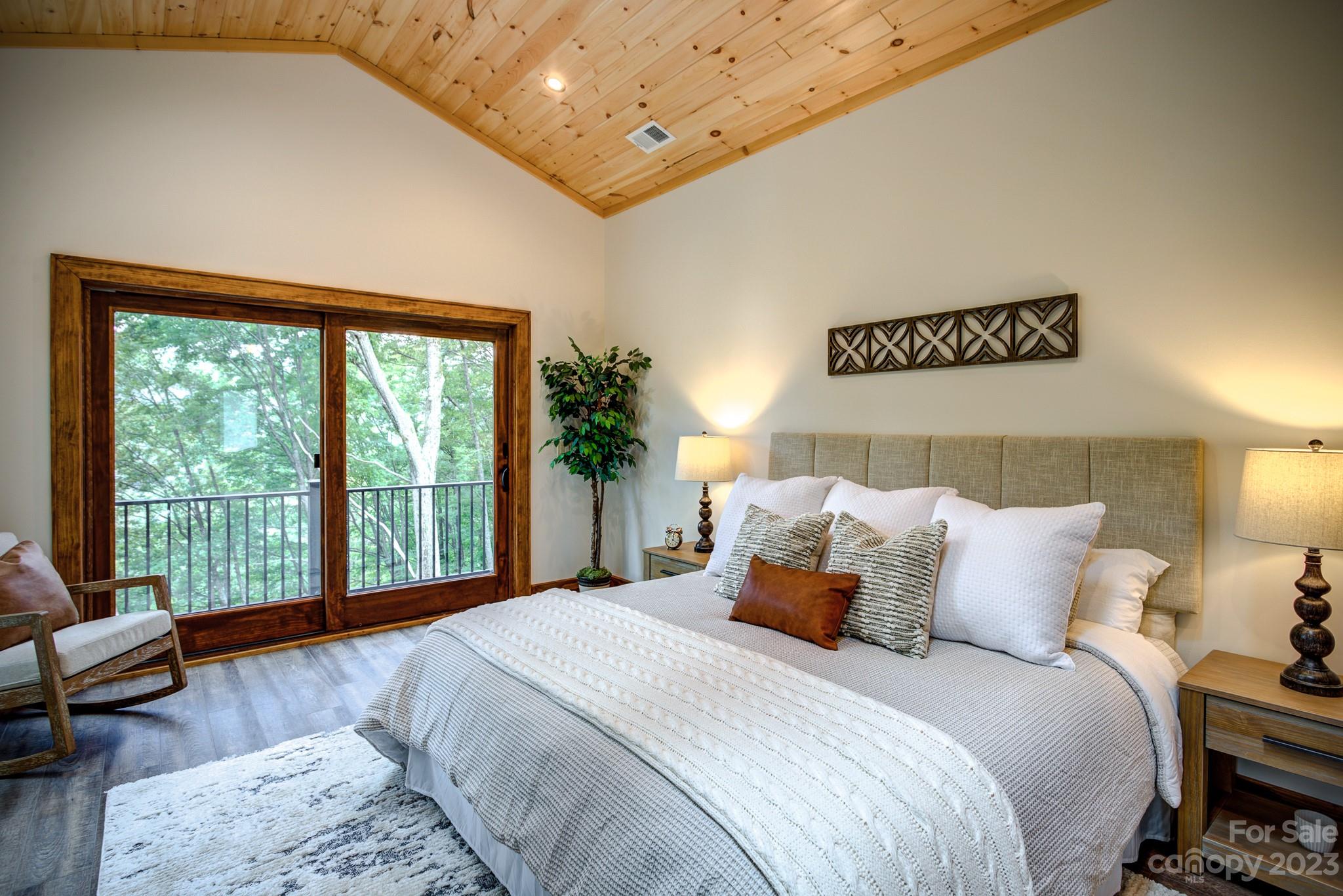 53 Laurel Ridge Lane, Unit 26 Banner Elk, NC 28604 - Photo 21 of 41 a bedroom with a large bed and a large window