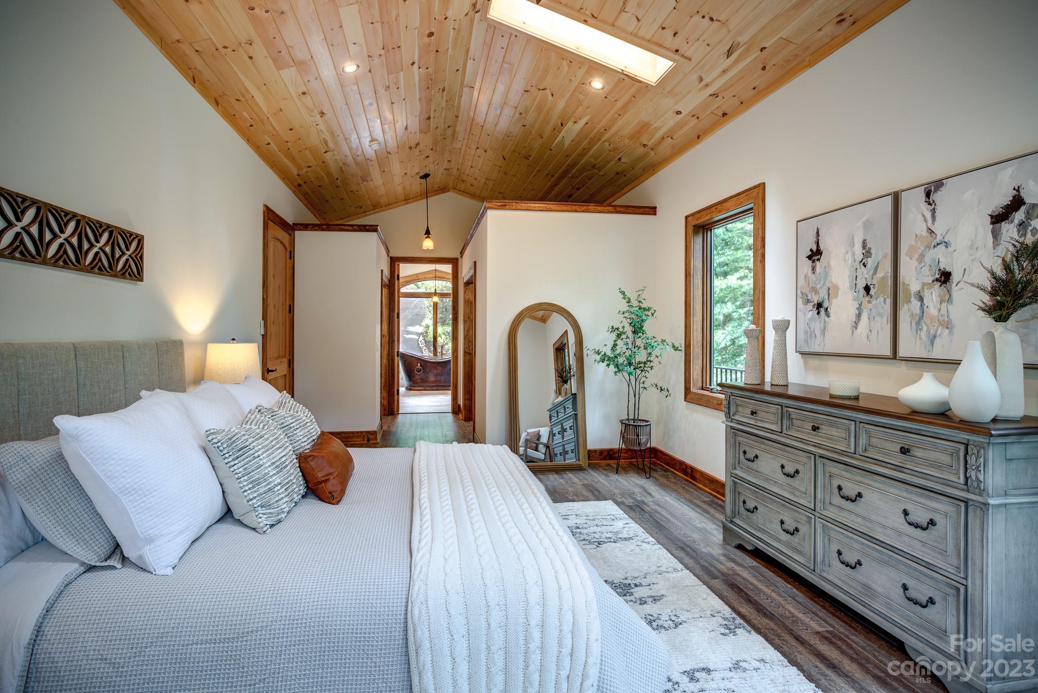 53 Laurel Ridge Lane, Unit 26 Banner Elk, NC 28604 - Photo 22 of 41 a bedroom with a large bed and wooden floor