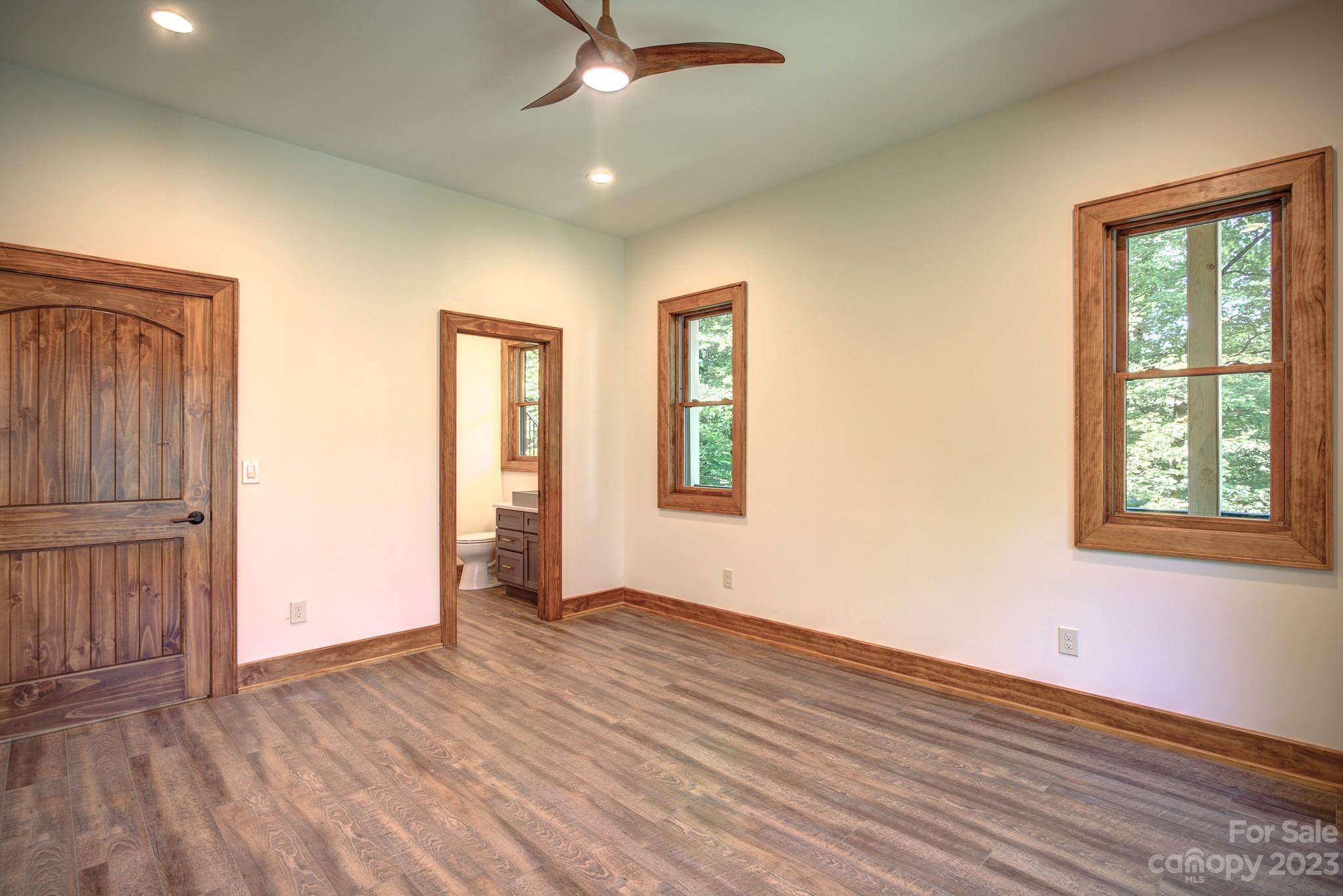 53 Laurel Ridge Lane, Unit 26 Banner Elk, NC 28604 - Photo 31 of 41 a view of an empty room with wooden floor and a window