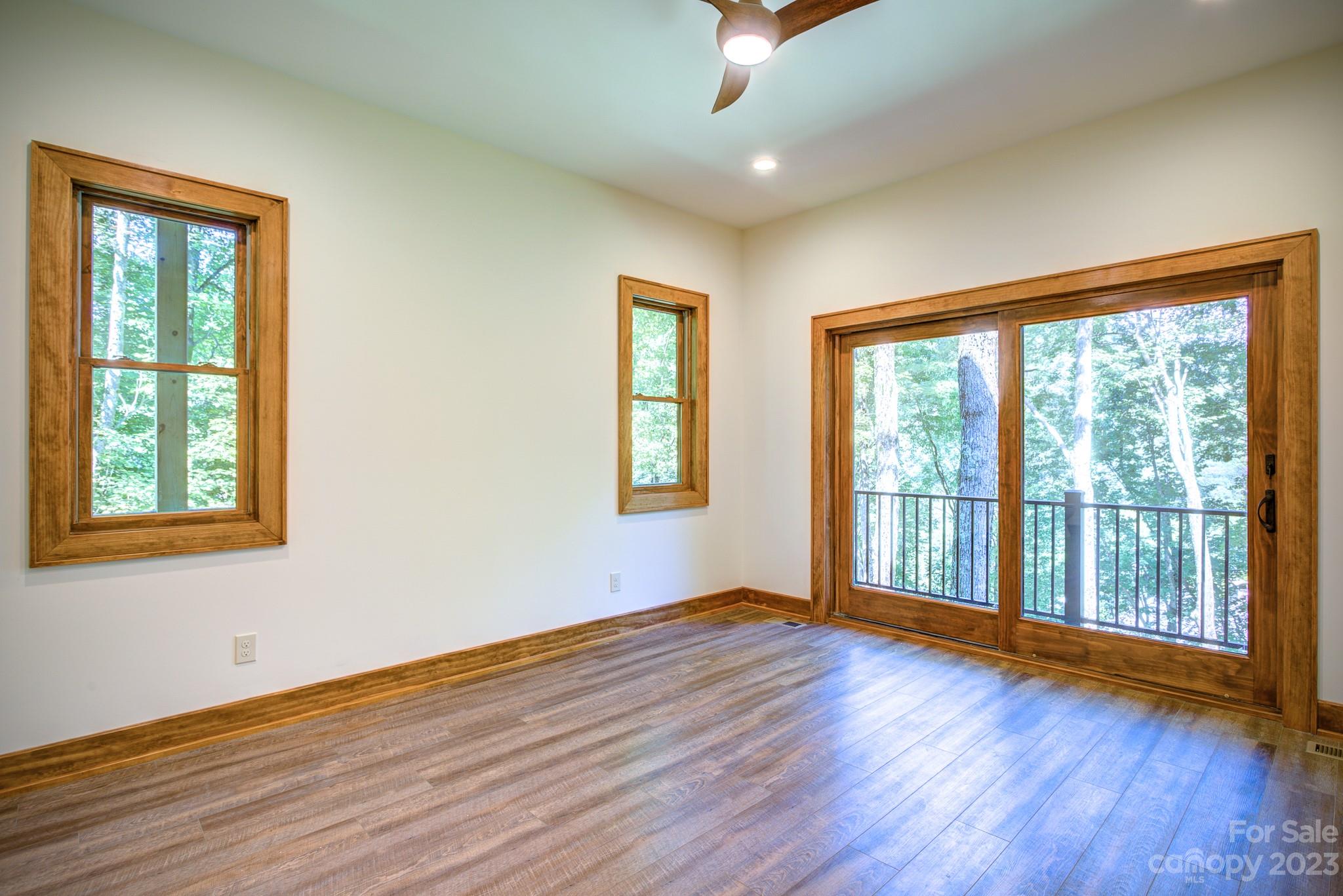 53 Laurel Ridge Lane, Unit 26 Banner Elk, NC 28604 - Photo 32 of 41 a view of an empty room with wooden floor and a window