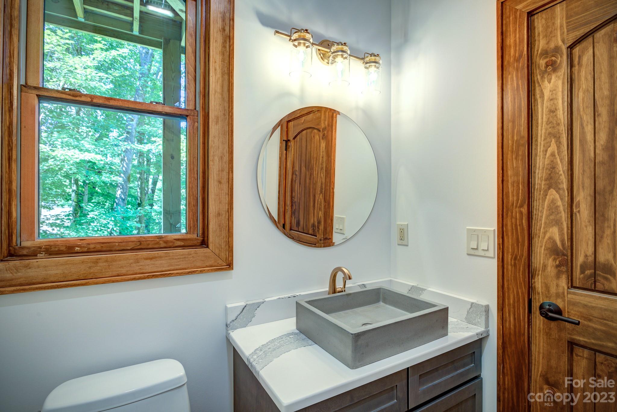 53 Laurel Ridge Lane, Unit 26 Banner Elk, NC 28604 - Photo 33 of 41 a bathroom with a toilet sink and mirror