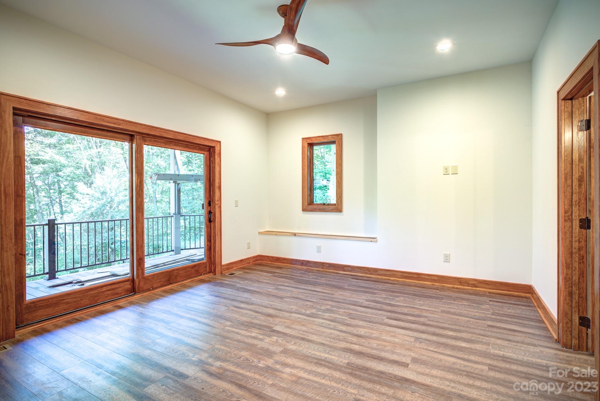 53 Laurel Ridge Lane, Unit 26 Banner Elk, NC 28604 - Photo 34 of 41 a view of an empty room with wooden floor and a window