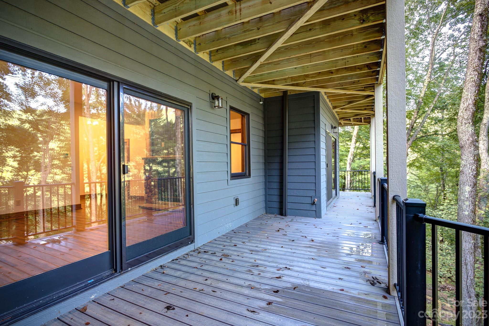 53 Laurel Ridge Lane, Unit 26 Banner Elk, NC 28604 - Photo 38 of 41 a view of a porch with wooden floor and floor to ceiling window