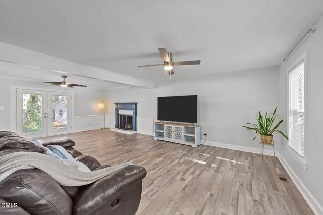 a spacious bedroom with a bed and a flat screen tv