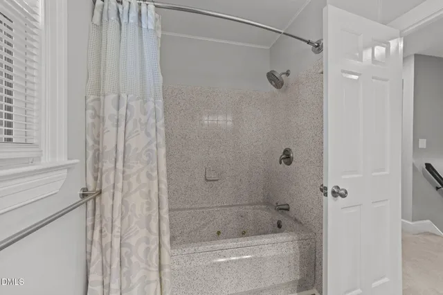 a bathroom with a shower and a tub