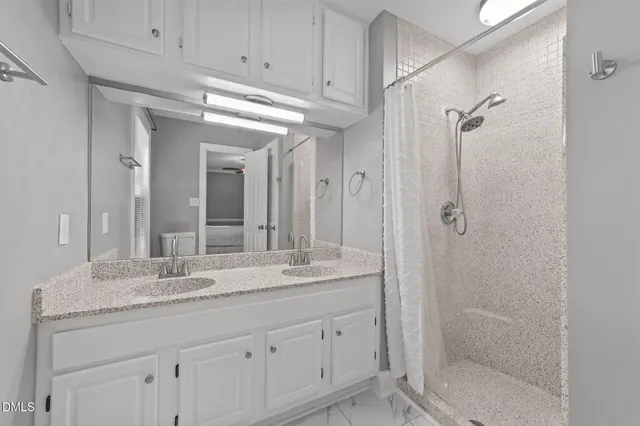 a bathroom with a shower sink and mirror
