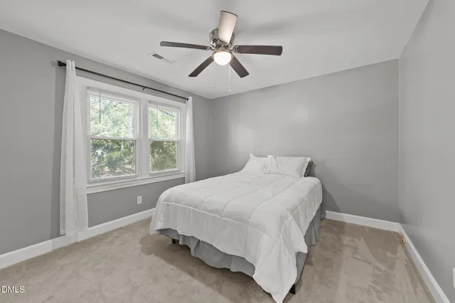 a bedroom with a bed and window