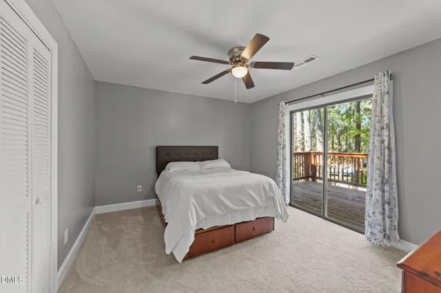 a bedroom with a bed and large window