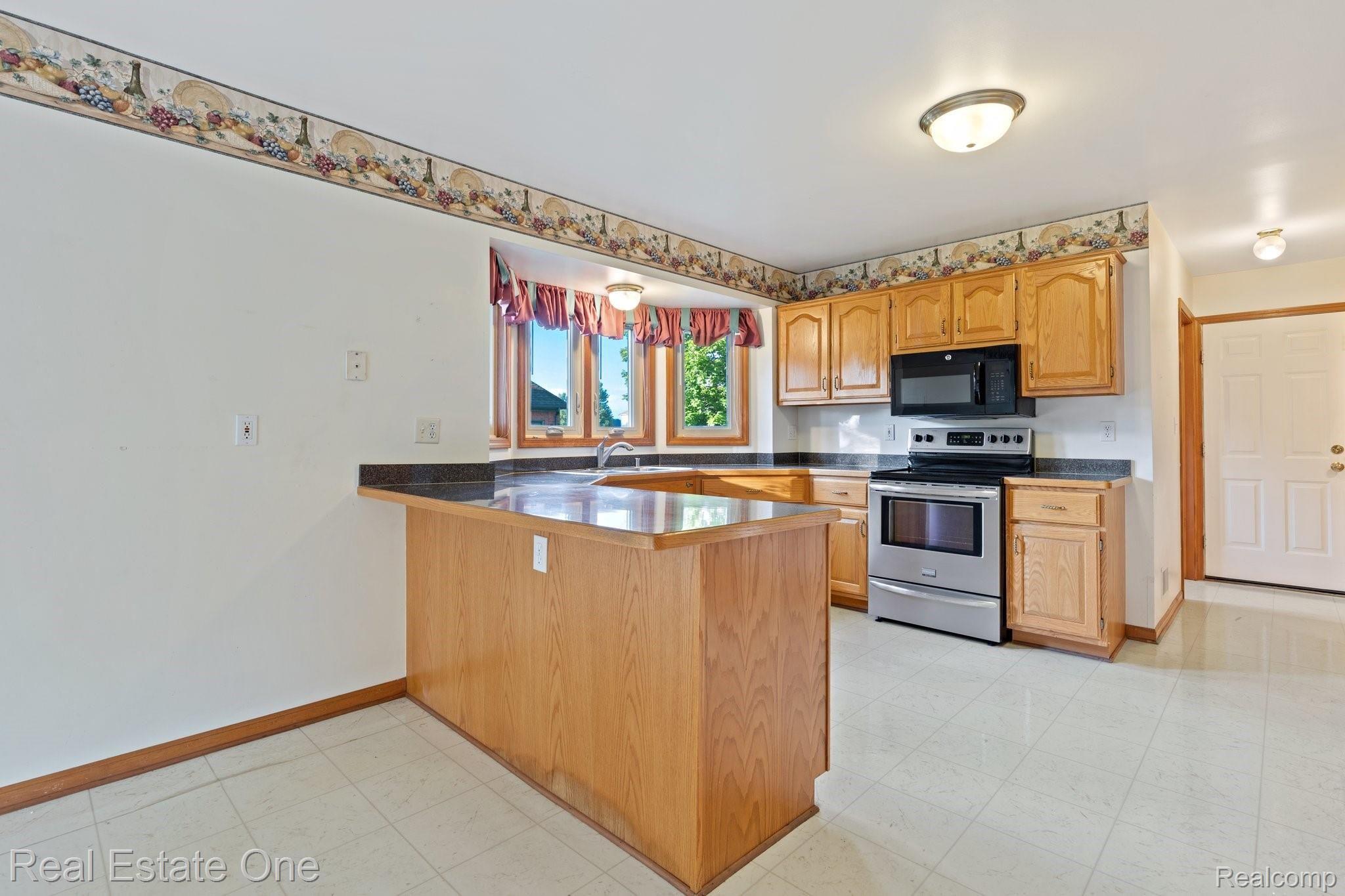 50009 Riverside Drive Macomb, MI 48044 - Photo 8 of 34 KITCHEN WORK AREA WITH STAINLESS STEEL APPLIANCES