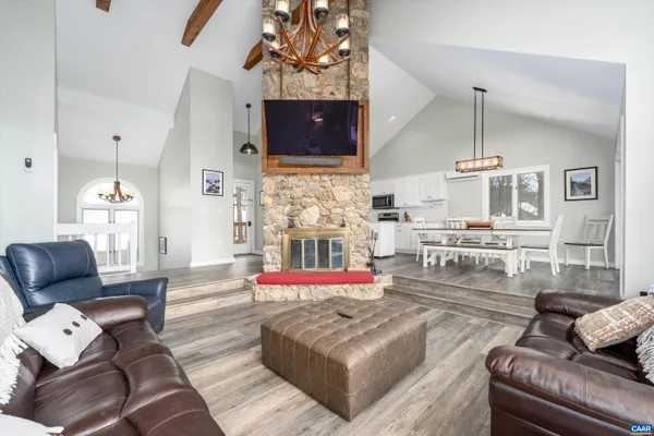a living room with furniture and a floor to ceiling window