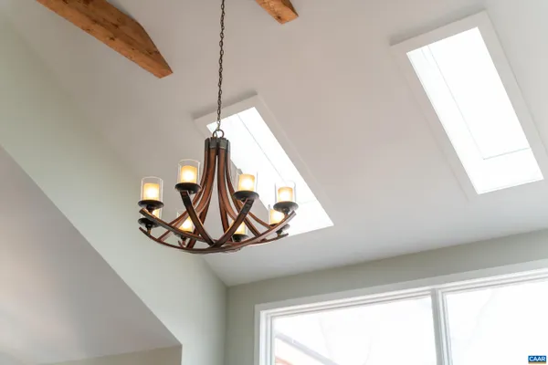 a dining room with furniture a chandelier and wooden floor