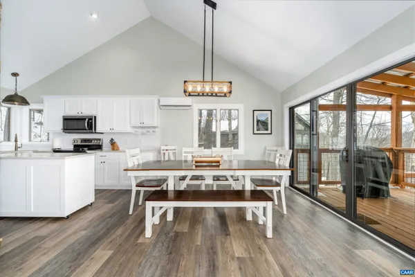 a kitchen with stainless steel appliances granite countertop a stove a sink and a white cabinets