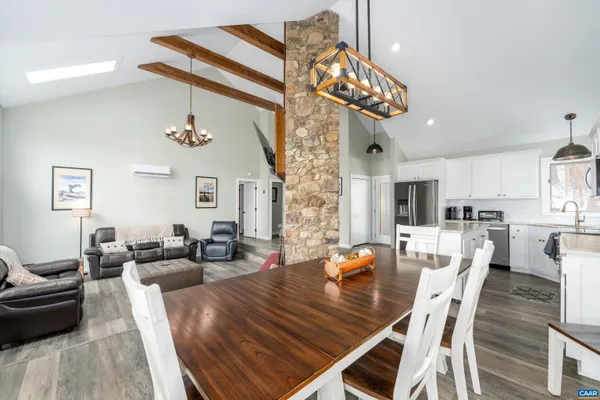 a kitchen with stainless steel appliances granite countertop a sink a stove a refrigerator and cabinets