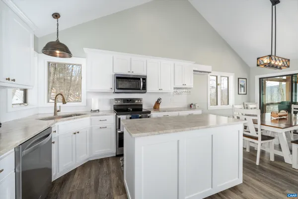a bathroom with a granite countertop toilet sink and mirror