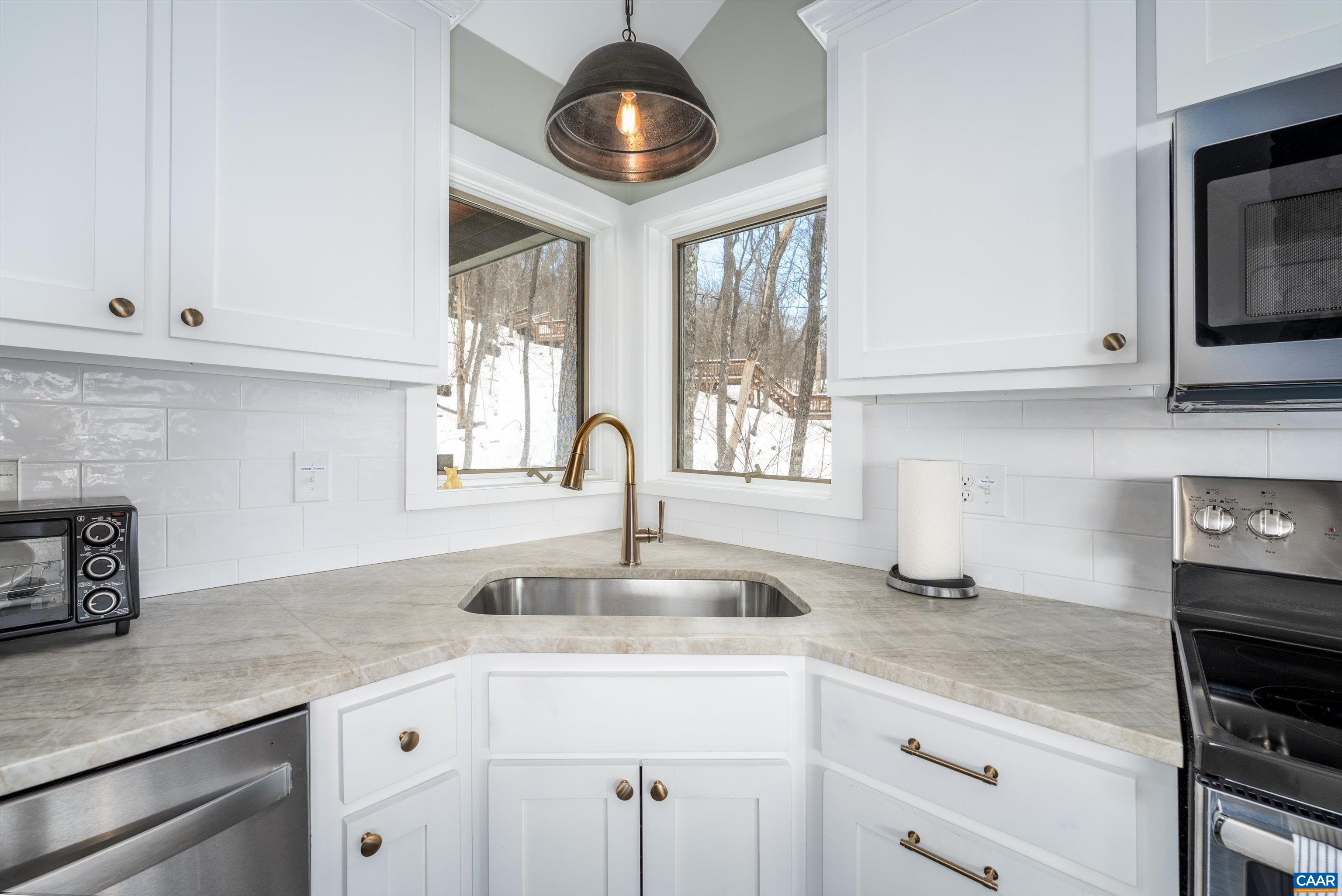 131 Crawfords Edge Wintergreen, VA 22967 - Photo 26 of 75 a kitchen with stainless steel appliances granite countertop a sink a stove and cabinets