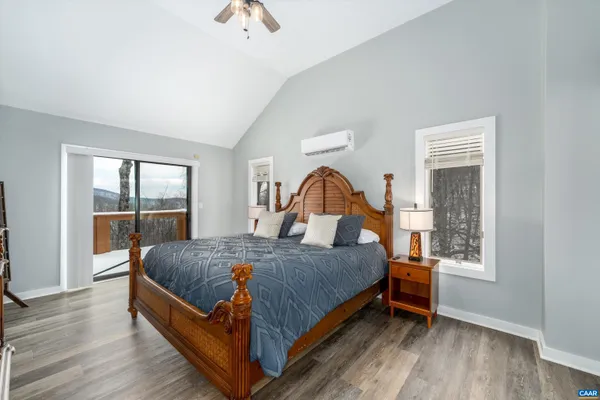 a view of a wooden deck with furniture and trees