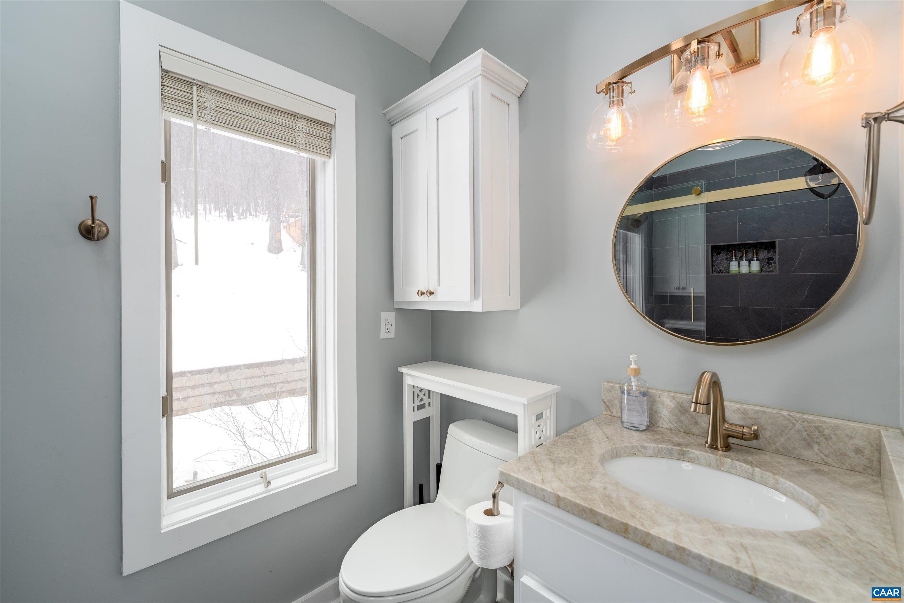 131 Crawfords Edge Wintergreen, VA 22967 - Photo 37 of 75 a bathroom with a granite countertop toilet sink and mirror