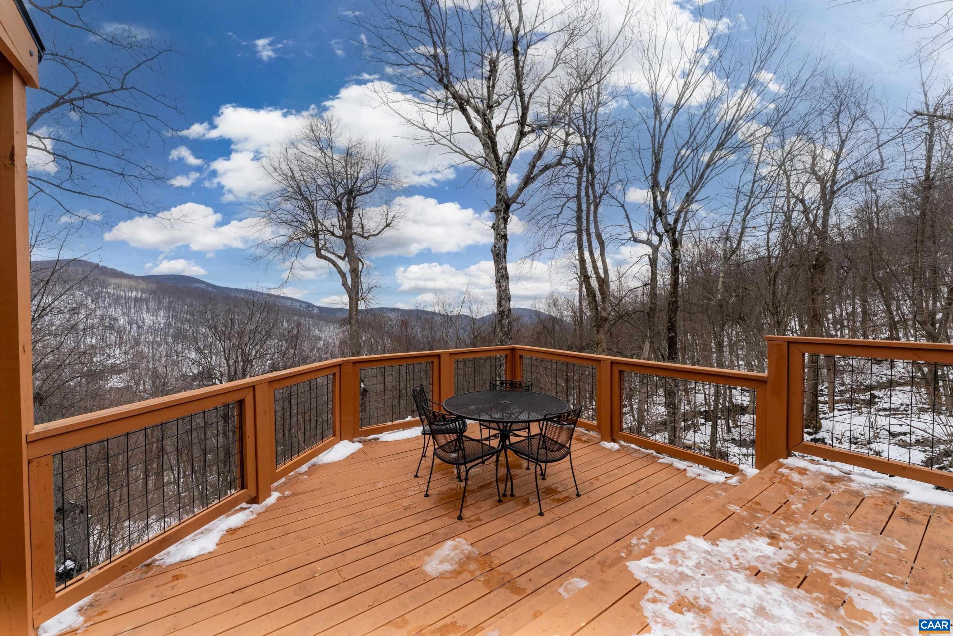 131 Crawfords Edge Wintergreen, VA 22967 - Photo 44 of 75 a view of a balcony with two chairs and a table