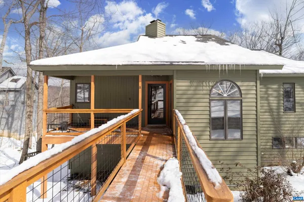 a living room with patio furniture and a wooden floor