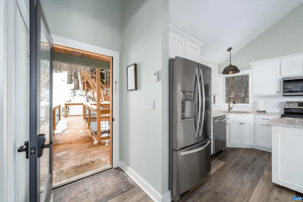 a living room with furniture and a large window with outer view