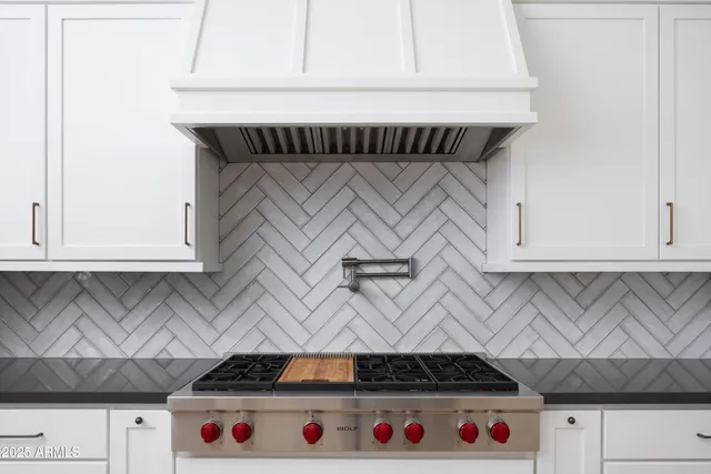 a kitchen with stainless steel appliances a sink stove and refrigerator