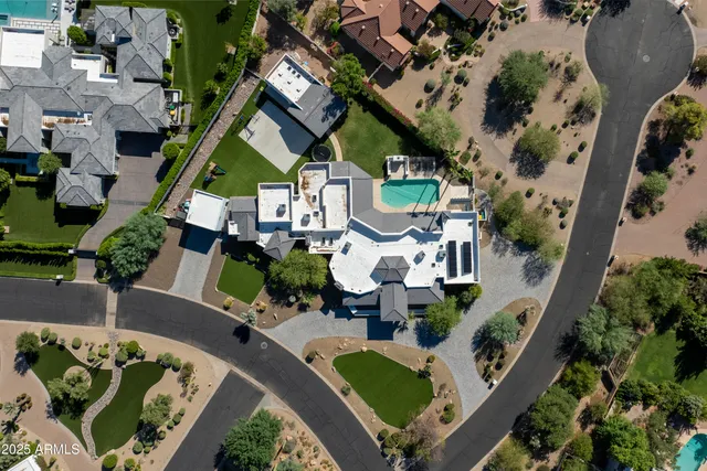 an aerial view of a house with a swimming pool