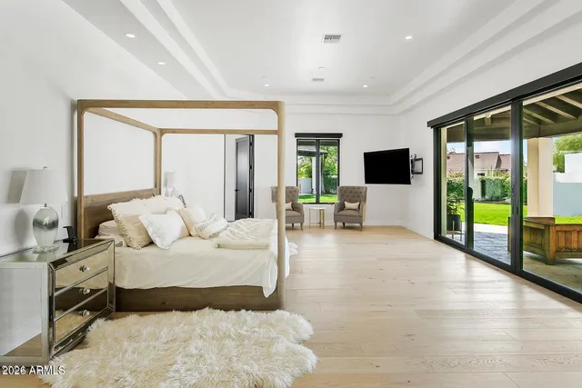 a bedroom with a large bed and a large window