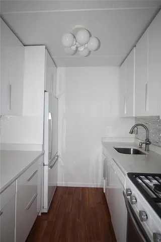 a kitchen with a sink stove and refrigerator