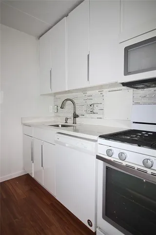 a kitchen with a stove and a microwave