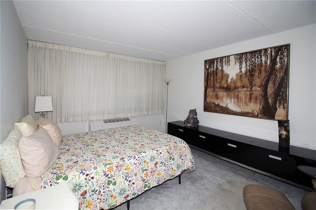 1160 Bower Hill Road, Unit 1101B Pittsburgh, PA 15243 - Photo 16 of 33 a bedroom with a bed and wooden floor